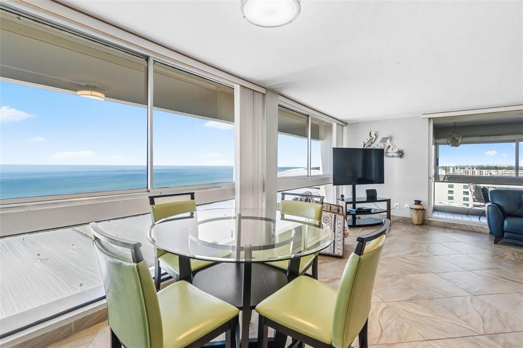 5966 Midnight Pass Road, Unit G113 Sarasota, FL 34242 - Photo 9 of 39 a living room with furniture a flat screen tv and a window
