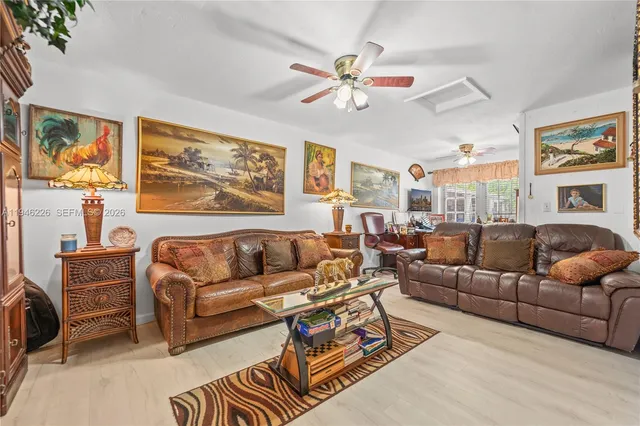 a living room with furniture ceiling fan and a rug