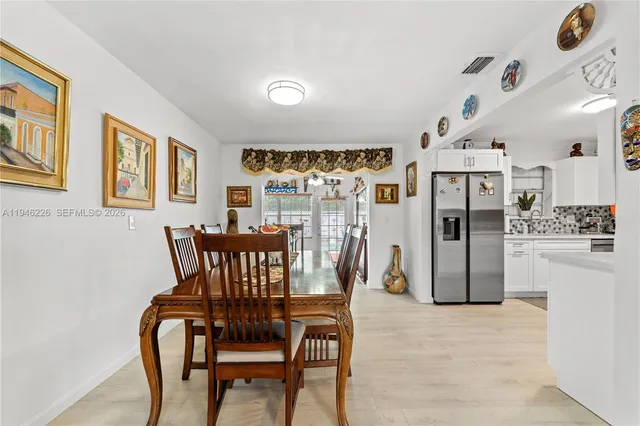 a view of a dining room with furniture and chandelier