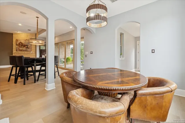 a kitchen with a refrigerator and white cabinets