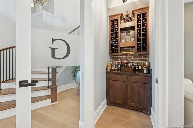a view of a hallway view with wooden floor and a living room