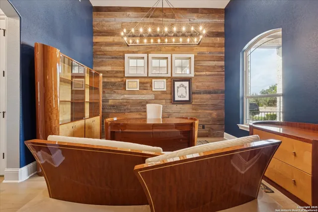 a bed sitting in a spacious bedroom next to a window