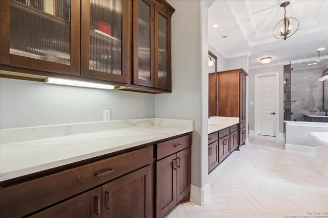 a bedroom with a bed lamp and a large window