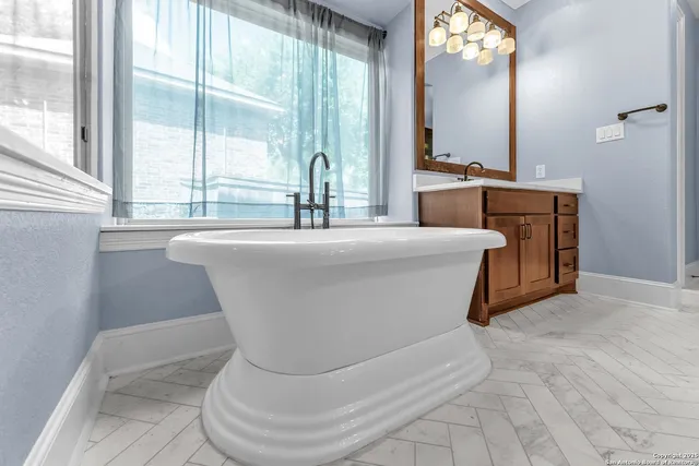 a living room with furniture a flat screen tv and a large window