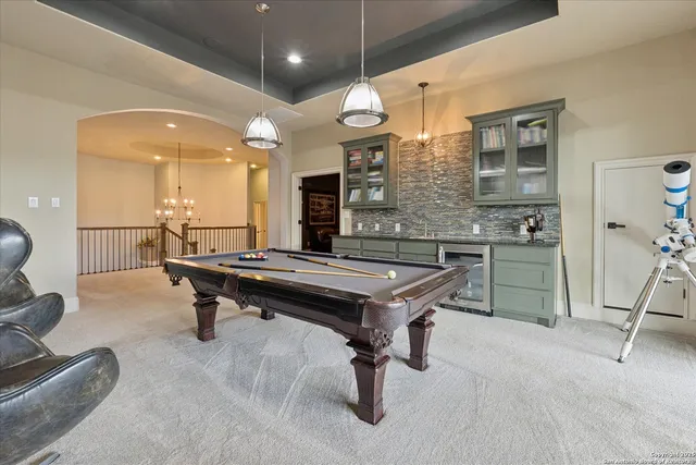 a large bed sitting in a bedroom next to a window