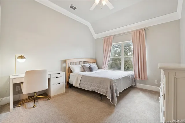 a bedroom with a bed chair and painting on the wall