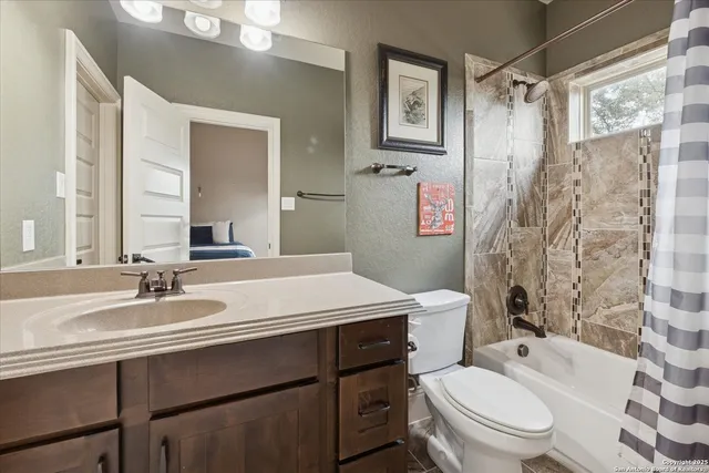 a view of dirt road with a large tree