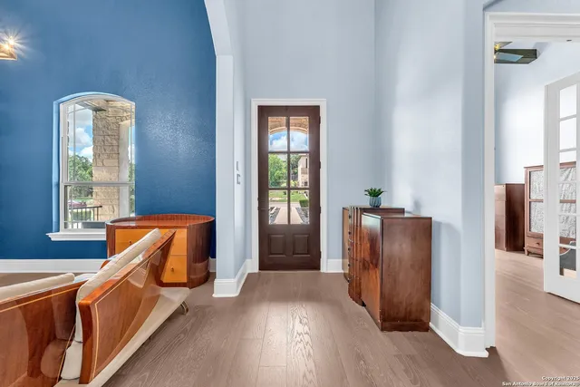 a large kitchen with stainless steel appliances granite countertop a stove oven and a view of dining hall with couches