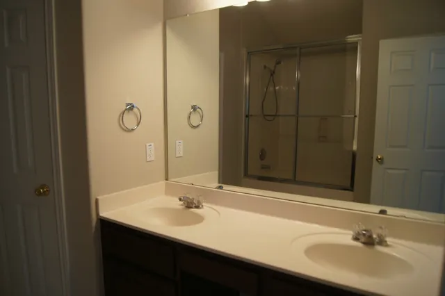 a white toilet sitting next to a white sink