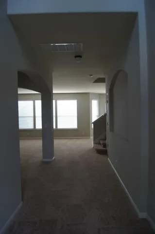 a view of empty room with a fireplace
