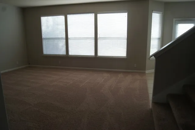 a kitchen with a sink a stove and cabinets