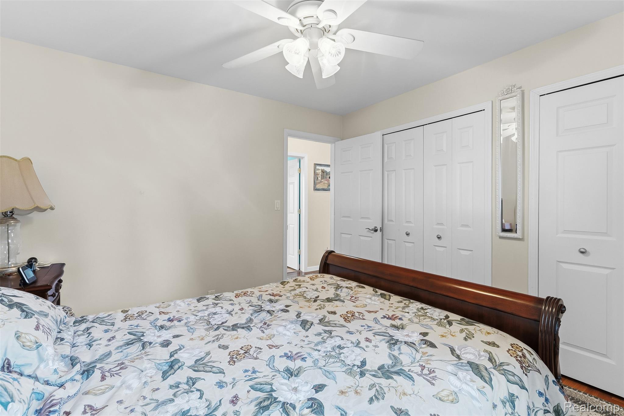 2227 North Graf Road Caro, MI 48723 - Photo 30 of 51 White ceiling fan with integrated lighting, white paneled doors, and light neutral wall color