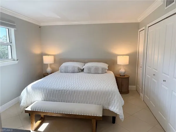 a bedroom with a bed and window