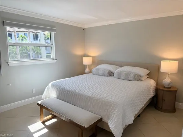 a bedroom with a bed and window