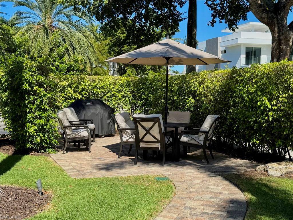 960 7th Street South, Unit 202 Naples, FL 34102 - Photo 15 of 16 a patio with table and chairs