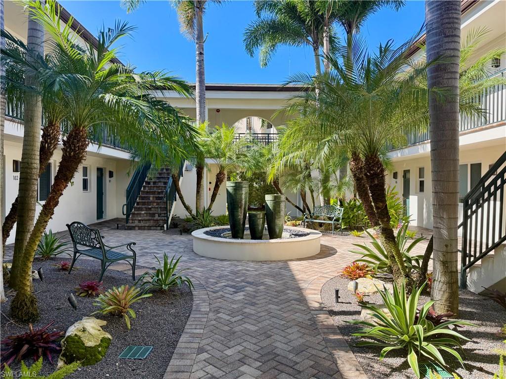 960 7th Street South, Unit 202 Naples, FL 34102 - Photo 2 of 16 a view of a potted plants in front of house