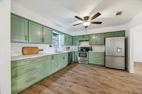 a kitchen with a refrigerator and a sink