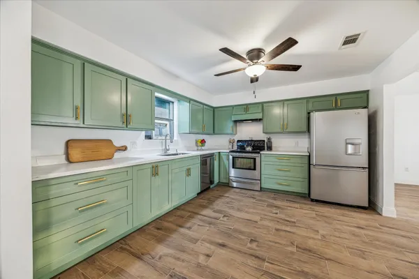 a kitchen with a refrigerator and a sink