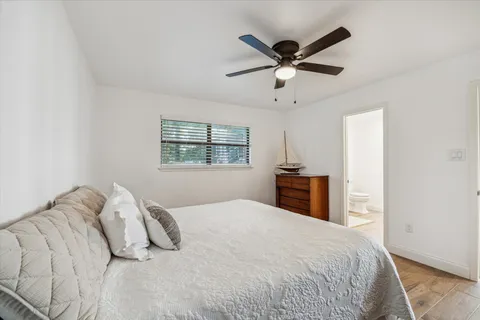 a bedroom with a large bed and a window
