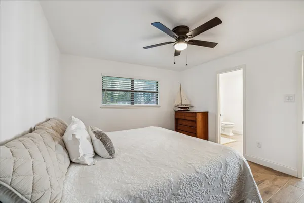 a bedroom with a large bed and a window