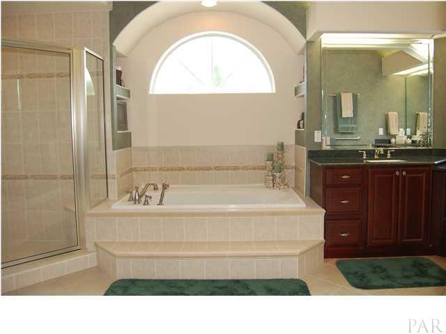 6060 Otter Point Road Pensacola, FL 32504 - Photo 12 of 23 Another shot of master suite with pocket sliders leading out to pool area