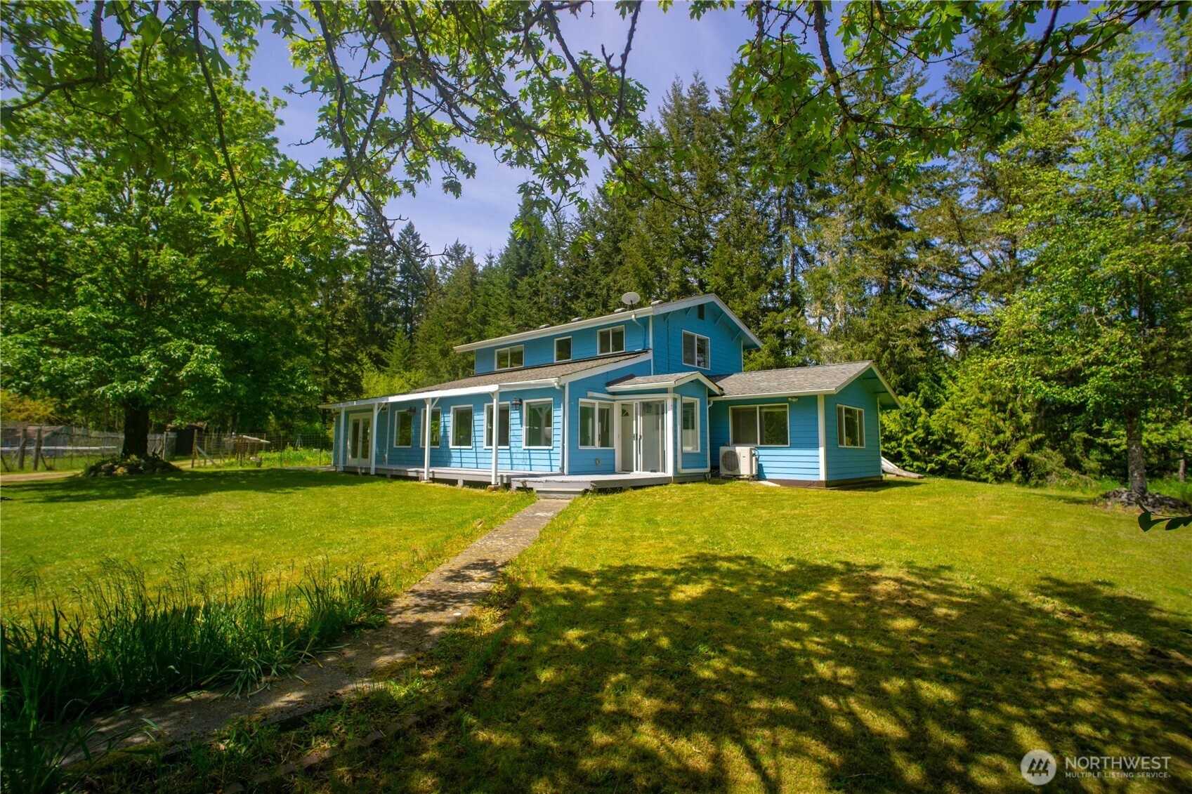 a front view of a house with yard and green space