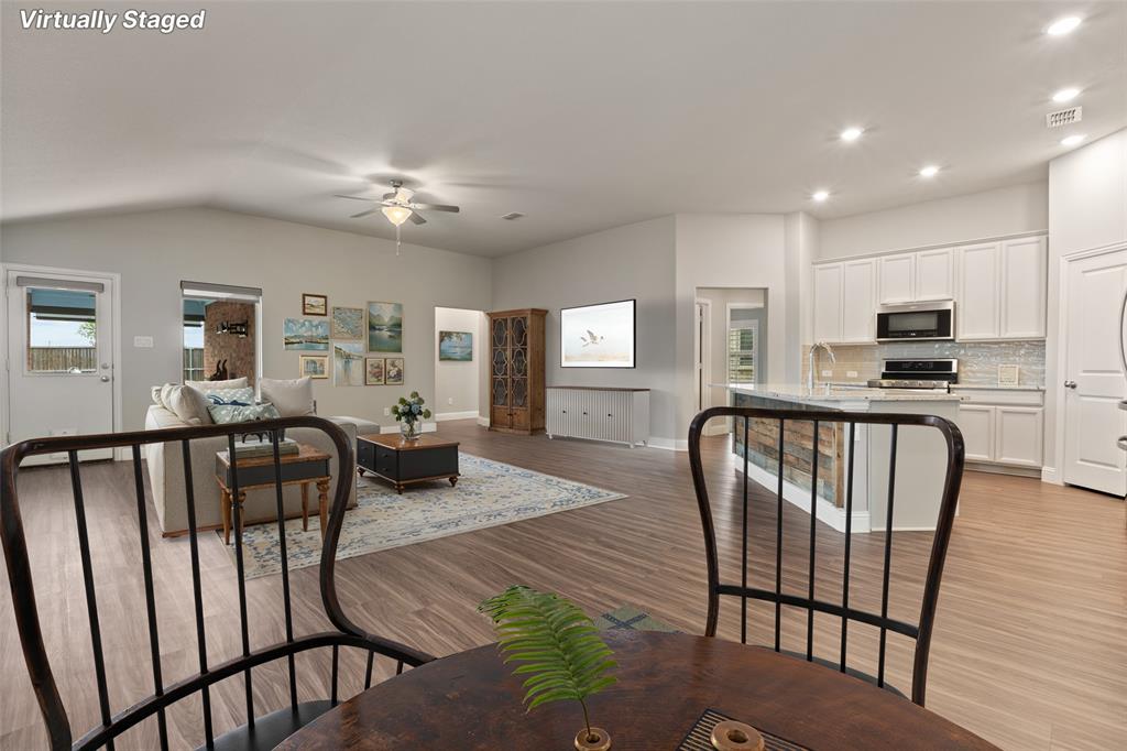 6909 Danridge Road Rowlett, TX 75089 - Photo 6 of 29 a view of a dining room with furniture and wooden floor