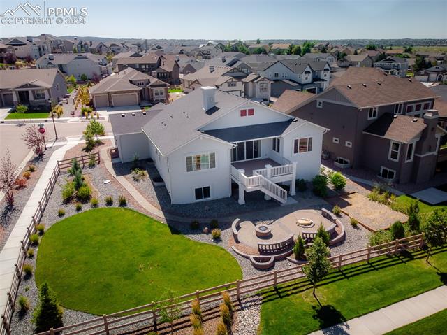 1940 Ruffino Drive Colorado Springs, CO 80921 - Photo 3 of 47 Rear view of home with nicely landscaped with fenced back yard and firepit.