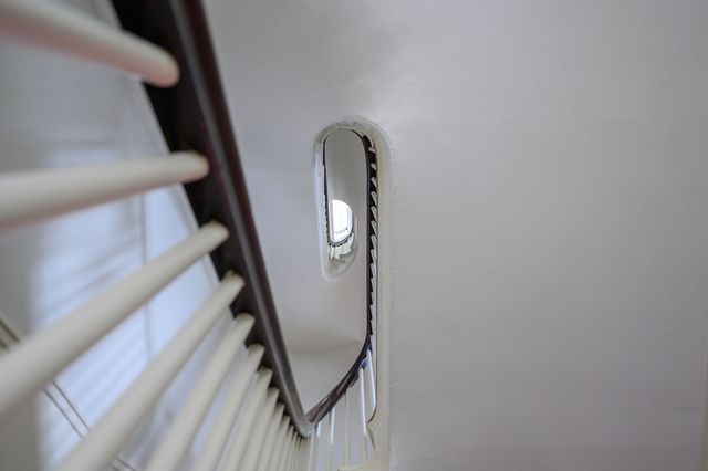 a view of staircase with railing and stairs