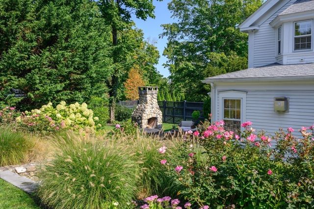 a view of a house with a flower garden