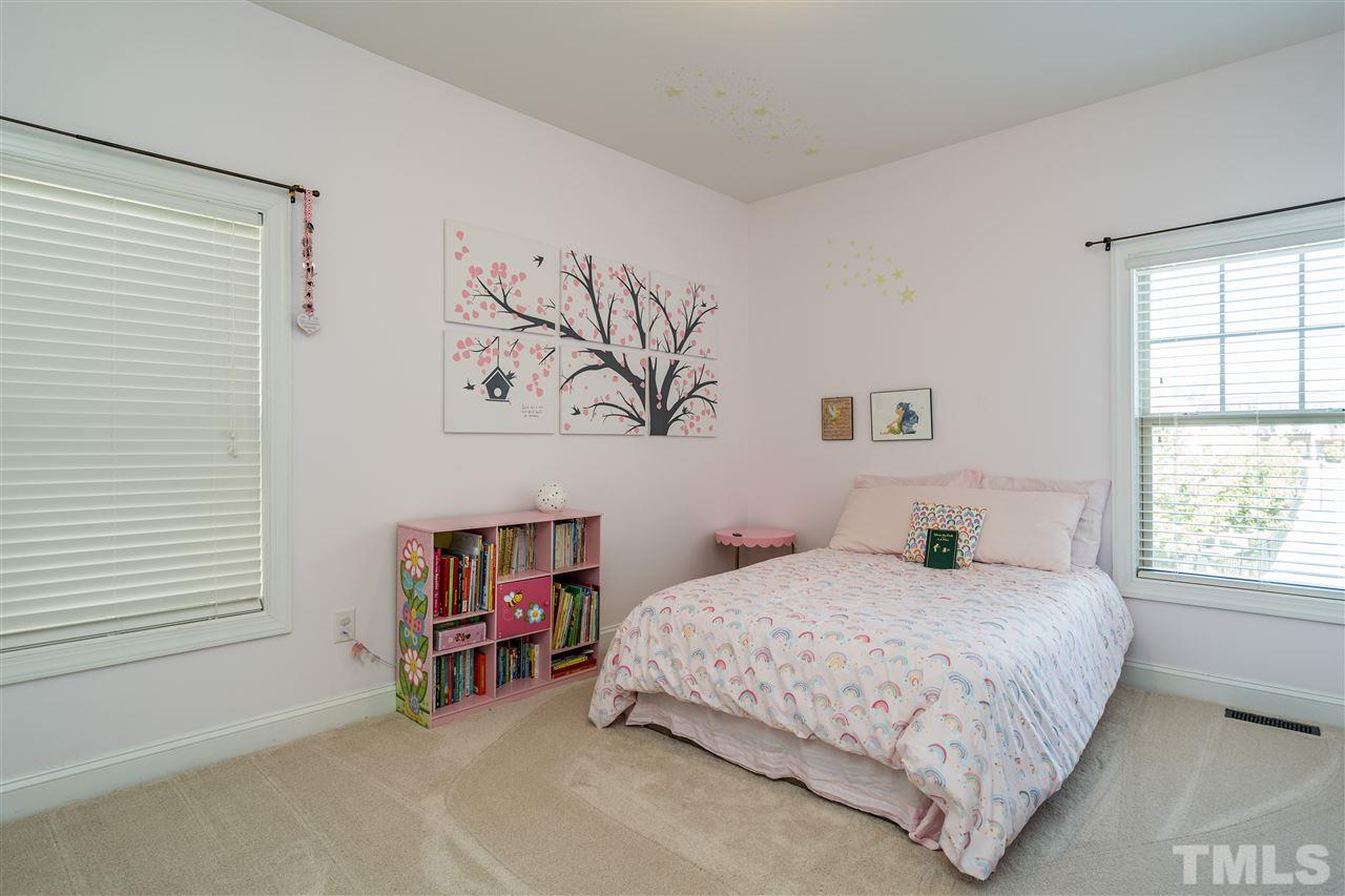 1411 Van Page Boulevard Raleigh, NC 27607 - Photo 21 of 26 a bedroom with a bed and a window