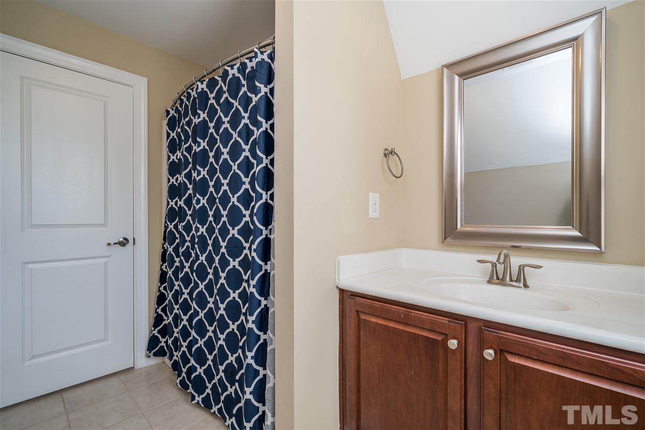 1411 Van Page Boulevard Raleigh, NC 27607 - Photo 22 of 26 a bathroom with a sink and a mirror