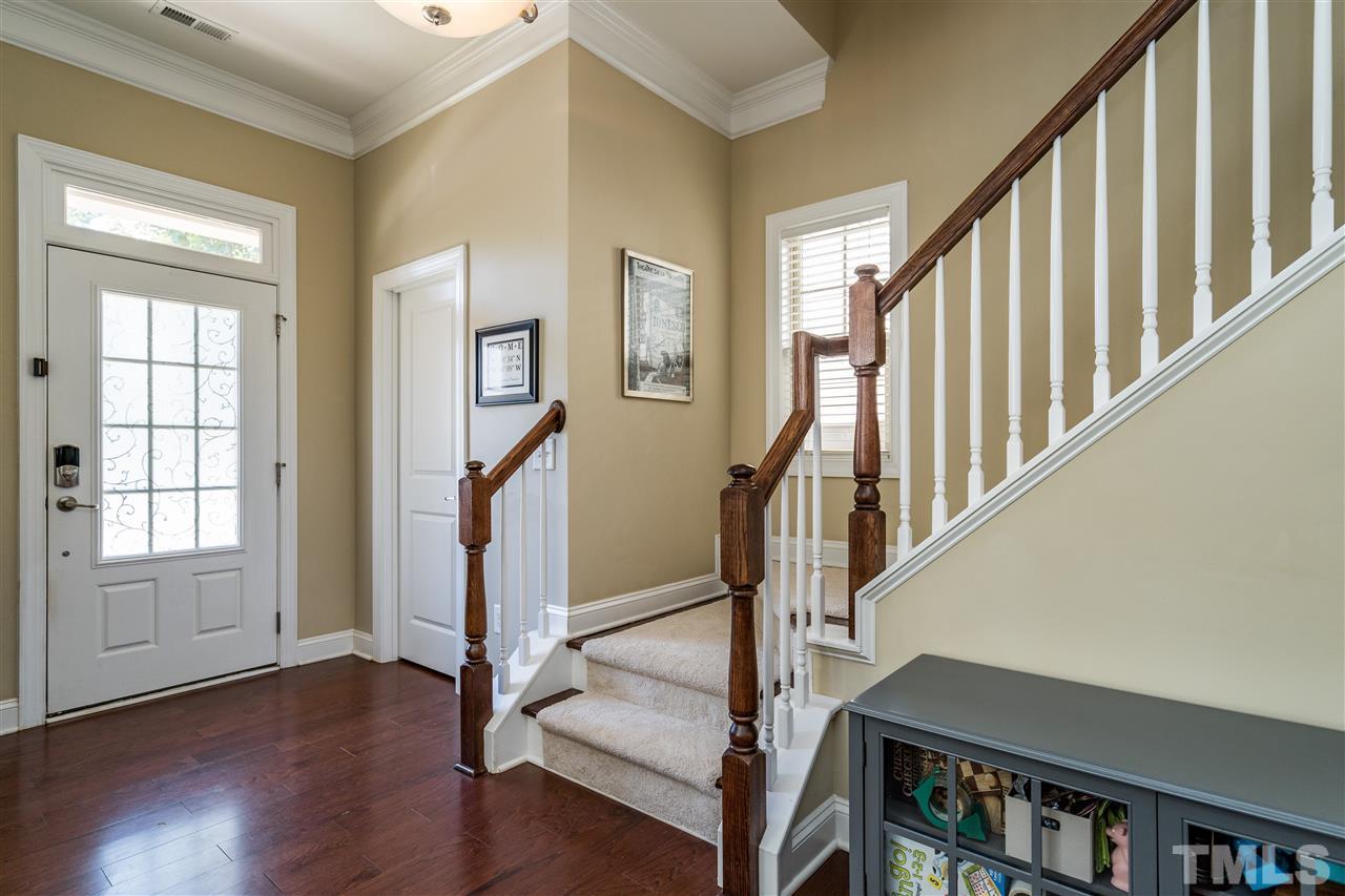 1411 Van Page Boulevard Raleigh, NC 27607 - Photo 4 of 26 a view of an entryway with wooden floor and door