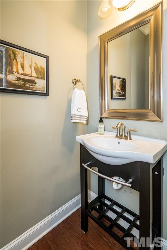 1411 Van Page Boulevard Raleigh, NC 27607 - Photo 5 of 26 a bathroom with a sink and a mirror
