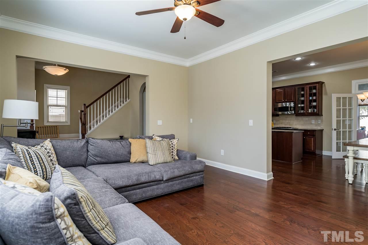 1411 Van Page Boulevard Raleigh, NC 27607 - Photo 8 of 26 a living room with furniture and a wooden floor