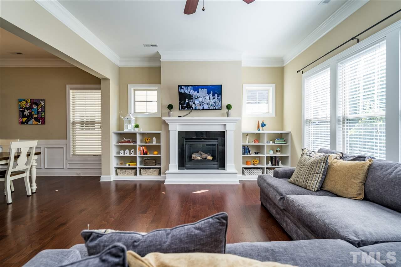 1411 Van Page Boulevard Raleigh, NC 27607 - Photo 9 of 26 a living room with furniture a fireplace and a large window