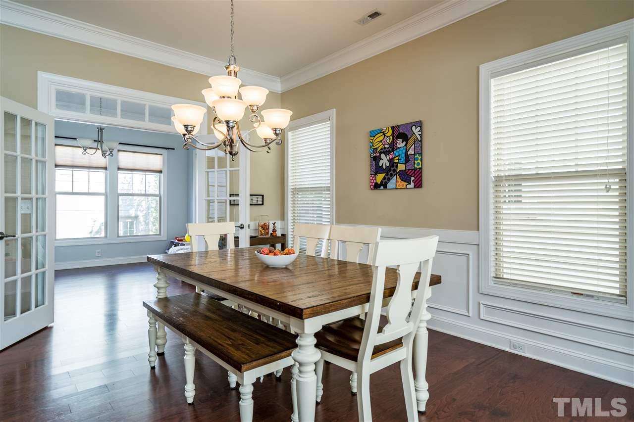 1411 Van Page Boulevard Raleigh, NC 27607 - Photo 10 of 26 a view of a dining room with furniture wooden floor and chandelier