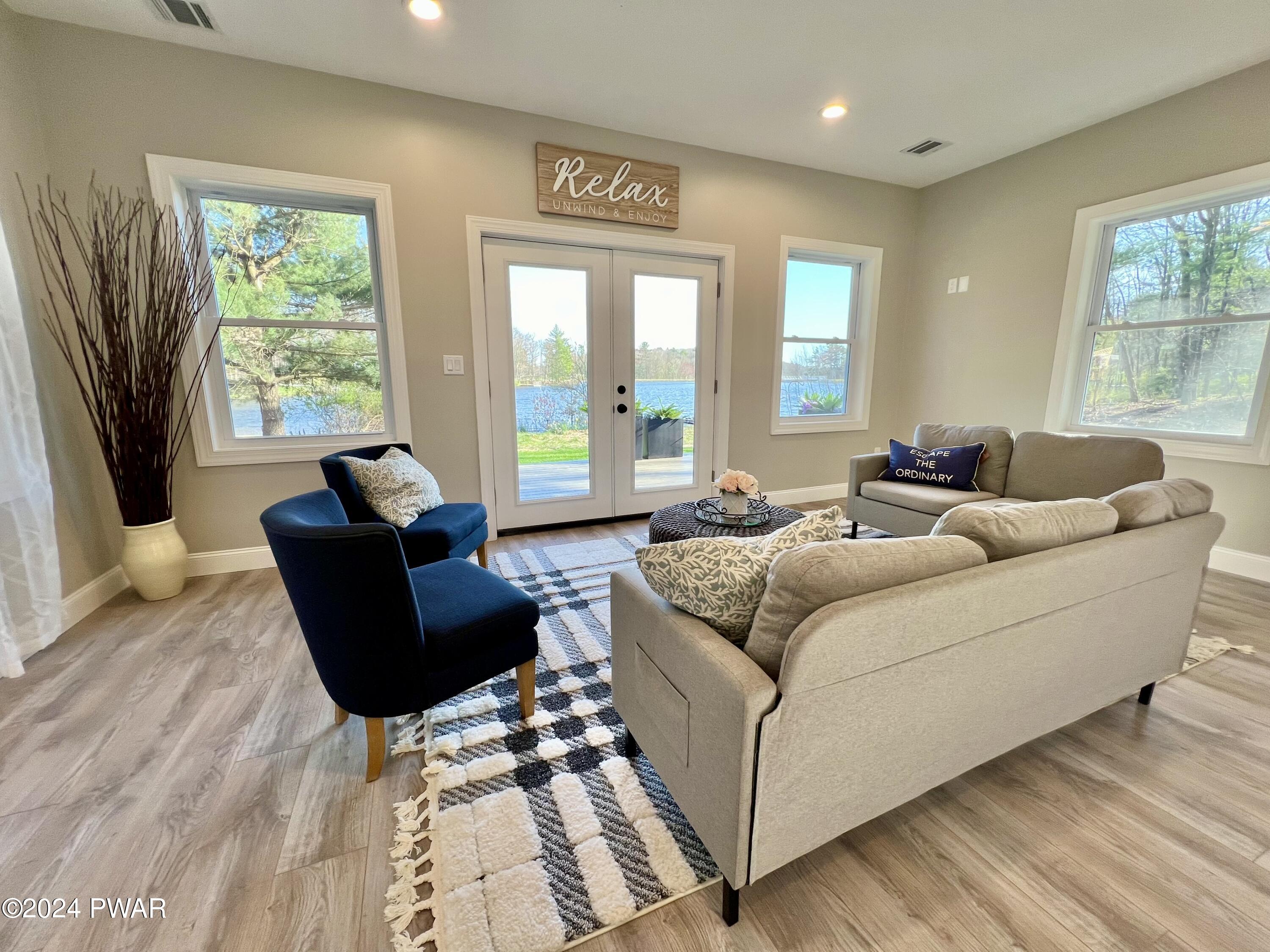 194 Aspen Road Dingmans Ferry, PA 18328 - Photo 13 of 29 a living room with furniture and a large window