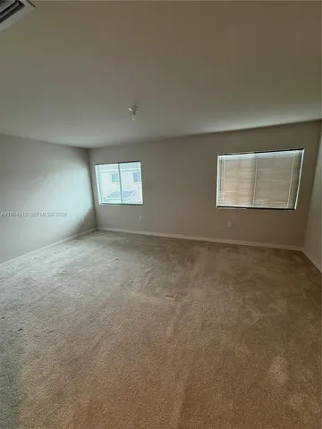 a spacious bathroom with a double vanity sink and mirror