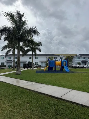 a front view of a house with plants