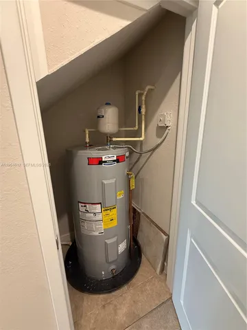 a bathroom with a granite countertop sink a toilet a mirror and shower