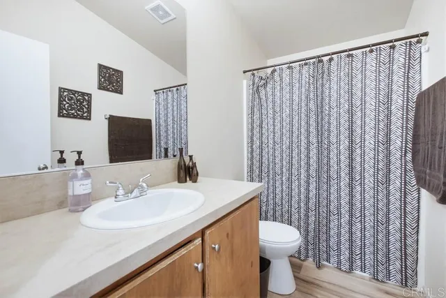 a bathroom with a sink toilet and mirror