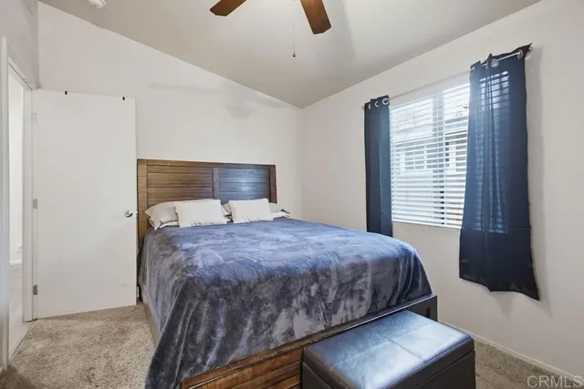 a bedroom with a bed and window