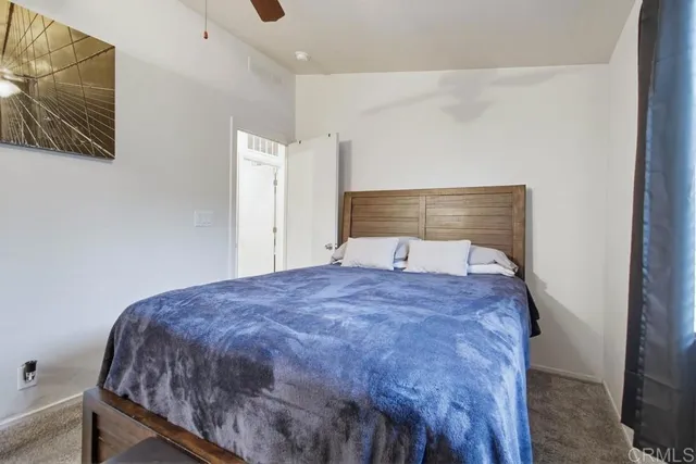 a bedroom with a bed and wall painting