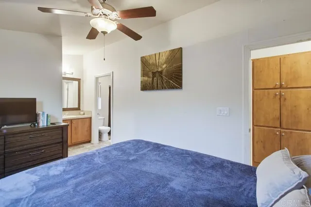 a bedroom with a bed and a television