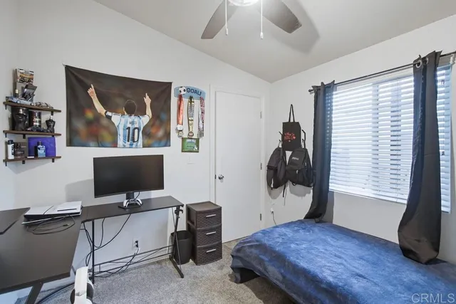 a bedroom with a workspace