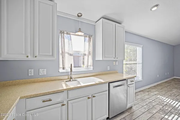 a kitchen with sink cabinets and window