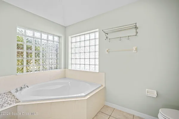 a white bath tub sitting next to a window