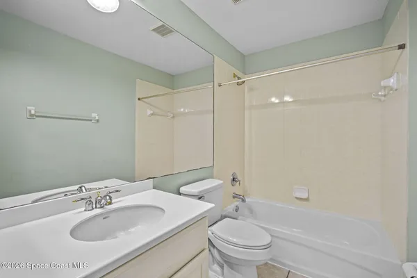 a bathroom with a sink toilet vanity and shower