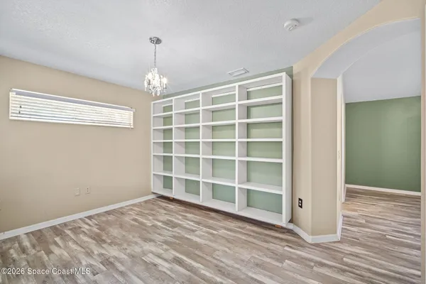 a view of wooden floor and windows in a room
